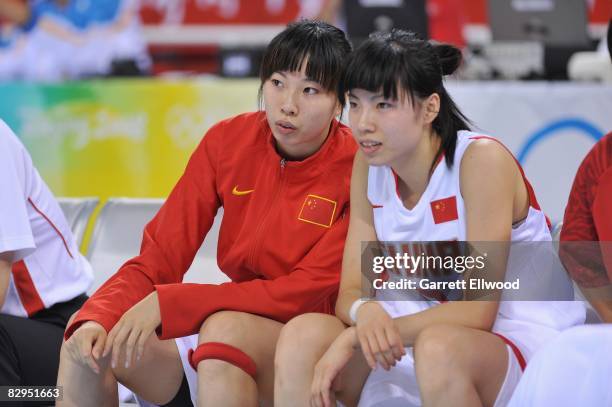 Yu Zhang and Wei Zhang of China watch the action from the bench during the women's preliminary round group B basketball match against Mali at the...