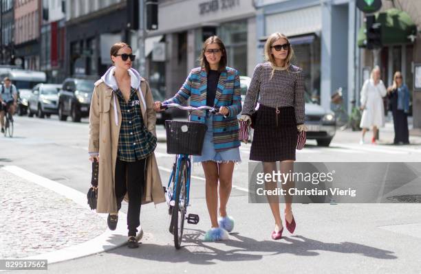 Lena Lademann, Darja Barannik with her bike and Tine Andrea outside Baum Und Pferdgarten on August 10, 2017 in Copenhagen, Denmark.