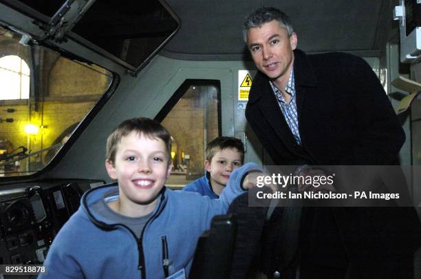 Olympic gold medallist and triple jump world record holder Jonathan Edwards is joined in the cab by his sons Nathan, aged nine, and Sam left, after...