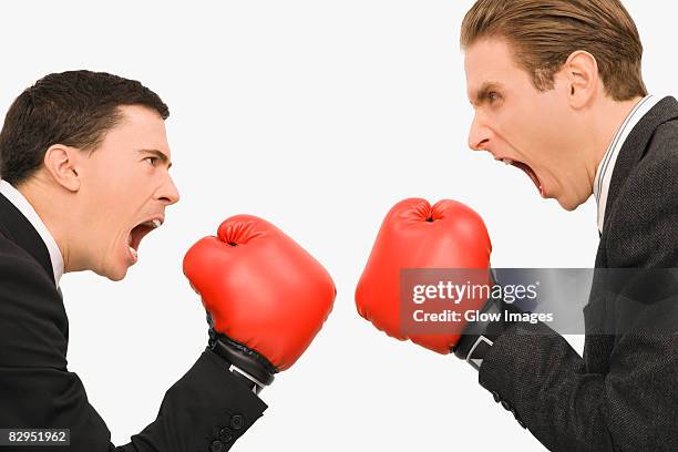 side profile of two businessmen boxing - punsch stock pictures, royalty-free photos & images