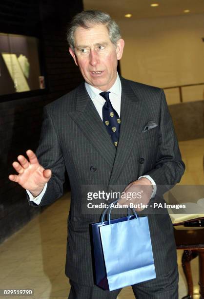 Britain's Prince of Wales holds a bag presented to him after making a speech at the Royal College of Physicians. In a keynote speech the Prince...