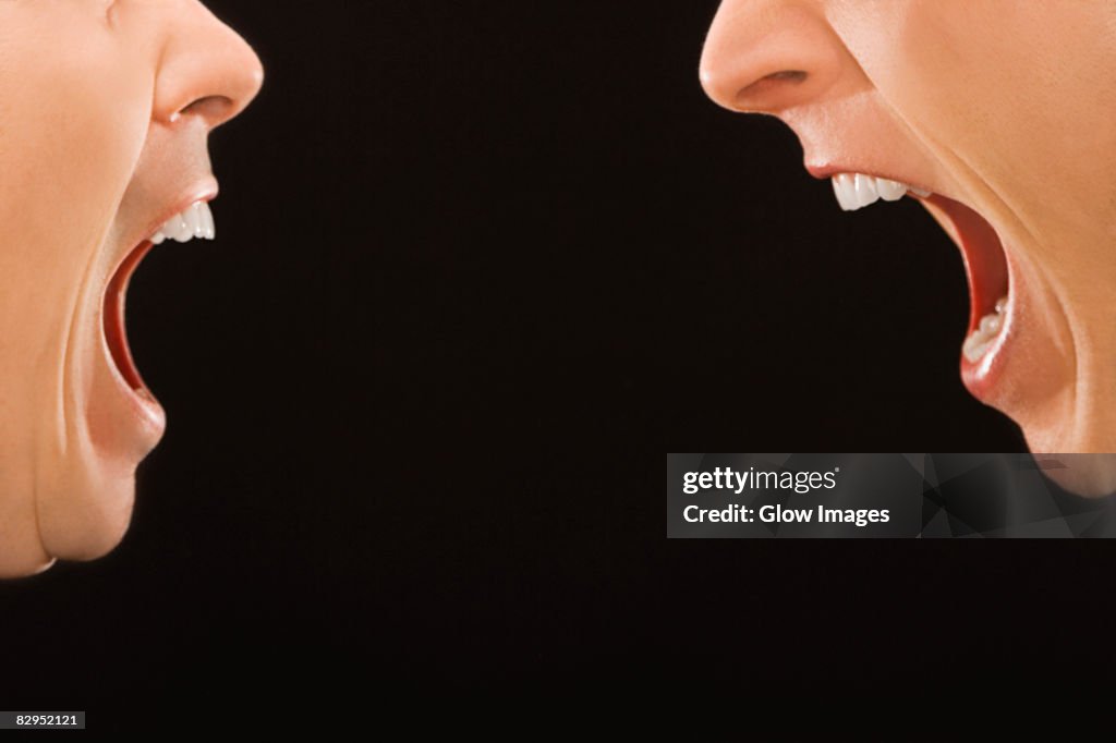 Close-up of two young men shouting at each other