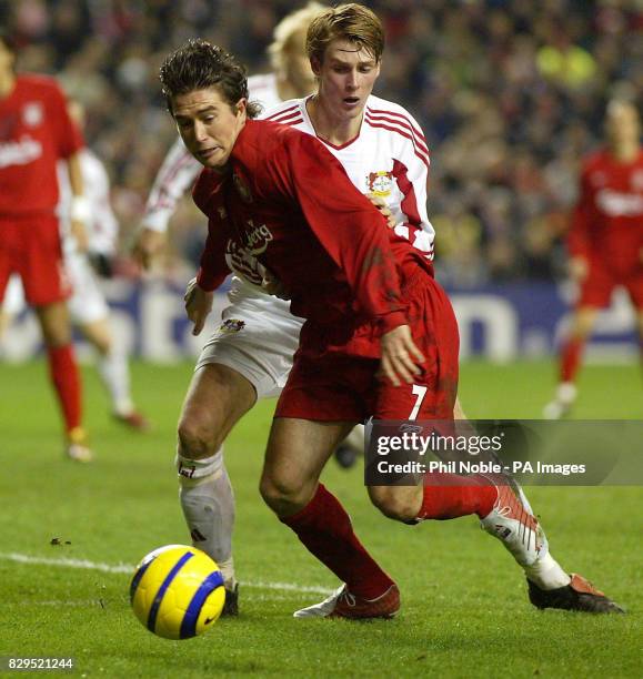 Liverpool's Harry Kewell battles with Bayer Leverkusen's Jan-Ingwer Callsen-Bracker .