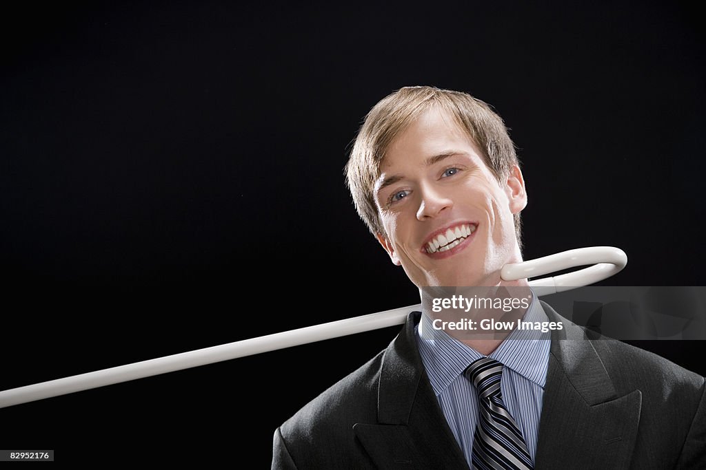 Portrait of a businessman smiling and being pulled by a cane