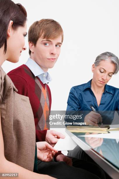 businessman giving a love letter to a businesswoman - business person handing over a letter fotografías e imágenes de stock