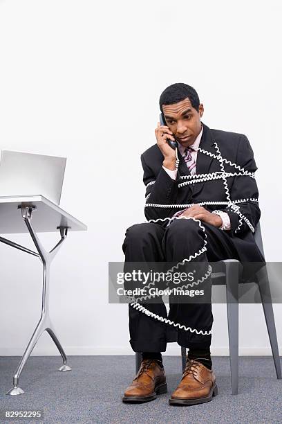 businessman trapped in a wire of a telephone - tangled stock pictures, royalty-free photos & images