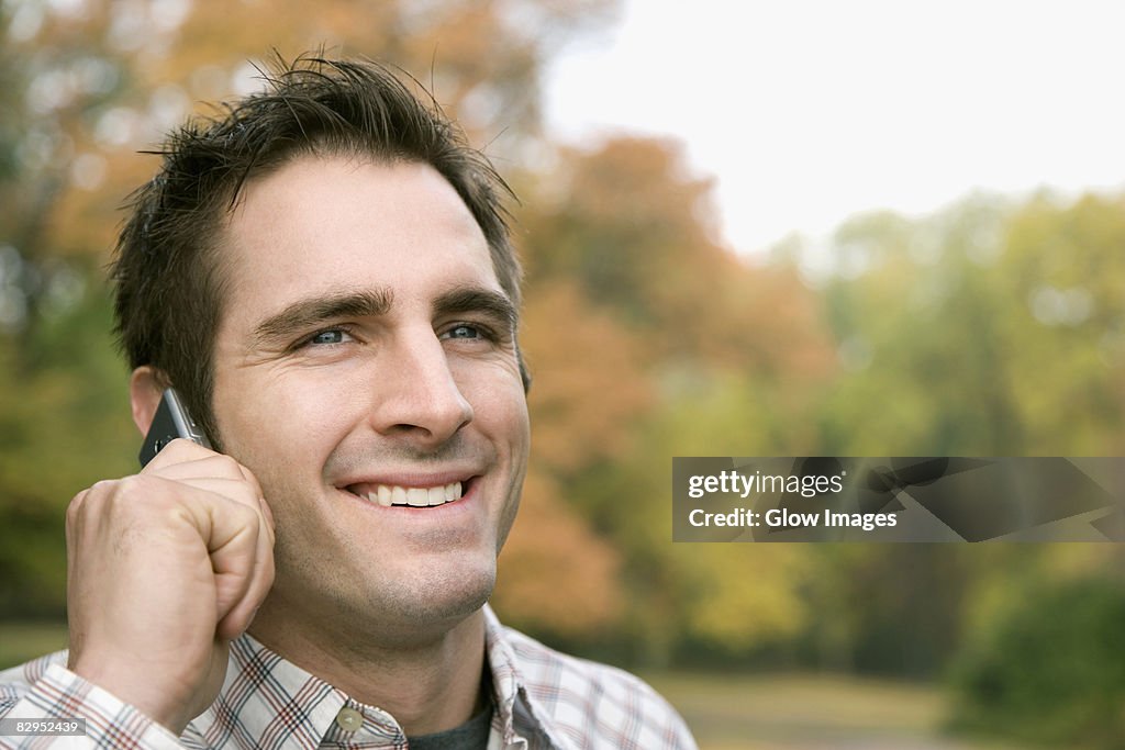 Close-up of a young man talking on a mobile phone