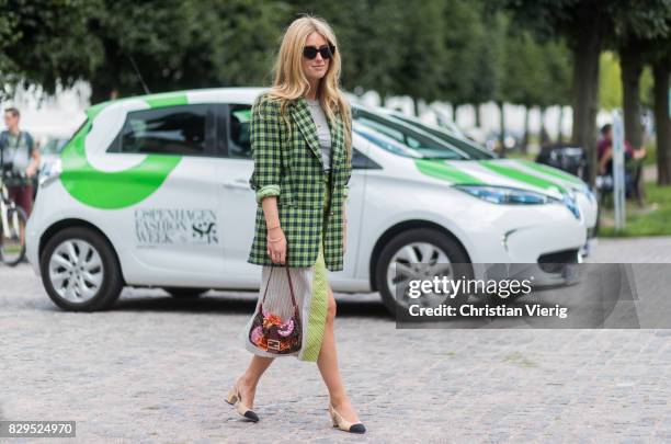 Emili Sindlev wearing green skirt and plaid blazer jacket, Chanel shoes outside Baum Und Pferdgarten on August 10, 2017 in Copenhagen, Denmark.