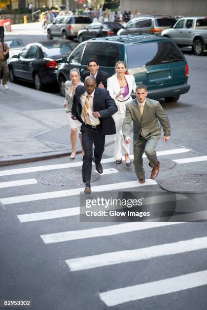 business executives chasing a businessman - people chasing stock pictures, royalty-free photos & images