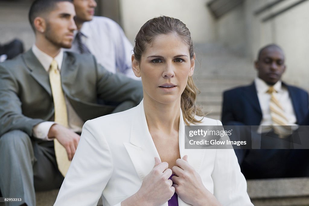 Close-up of a businesswoman holding the lapel of her coat