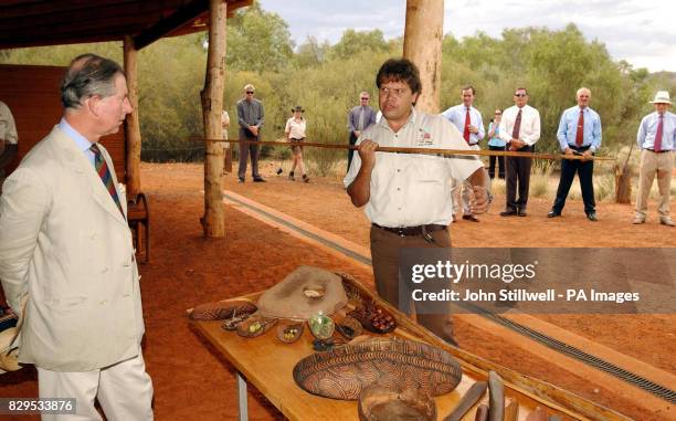 The Prince of Wales is shown by park Guide Doug Taylor how to throw an Aboriginal spear during his visit to the Desert Park on the outskirts of Alice...