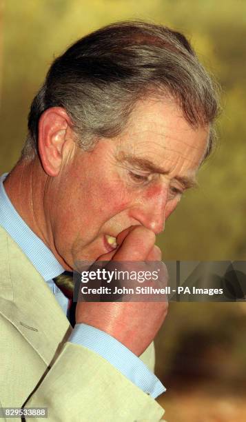 The Prince of Wales tastes a bush Banana during his visit to the Desert Park on the outskirts of Alice Springs.