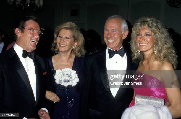 Roger Moore, wife, Johnny Carson, and Alexis Carson