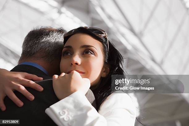 close-up of a businesswoman hugging a businessman - old man young woman stock pictures, royalty-free photos & images