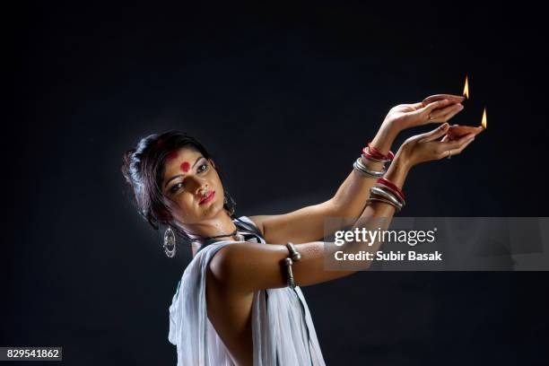 portrait of beautiful young woman holding diya - bangle stock pictures, royalty-free photos & images