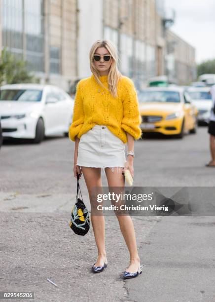 Camille Charriere wearing a yellow knit, mini skirt outside Ganni on August 10, 2017 in Copenhagen, Denmark.