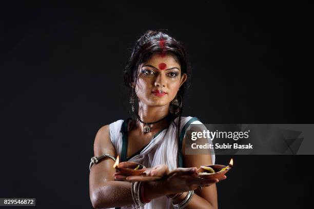 portrait of beautiful  young woman holding diya - diya oil lamp stock pictures, royalty-free photos & images