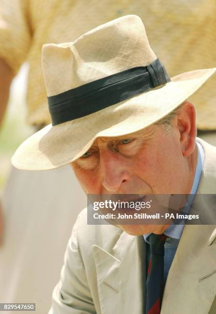 The Prince of Wales talks to a group of school children from the Malolo District School, having a lesson at the edge of the Pacific Ocean.