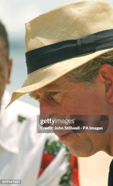 The Prince of Wales talks to a group of school children from the Malolo District School, having a lesson at the edge of the Pacific Ocean.