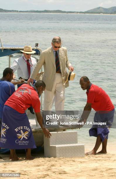 The Prince of Wales disembarks a boat.