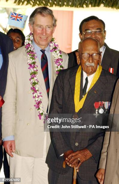 The Prince of Wales meets the oldest living Fijian man Bechu Prasad, 104.