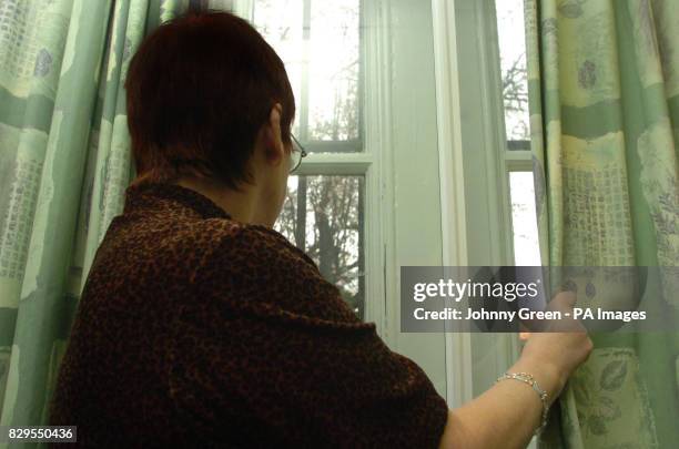 Brenda, looks out of a window after giving interviews to the media telling of her four years of violence and terrifying degradation at the hands of...