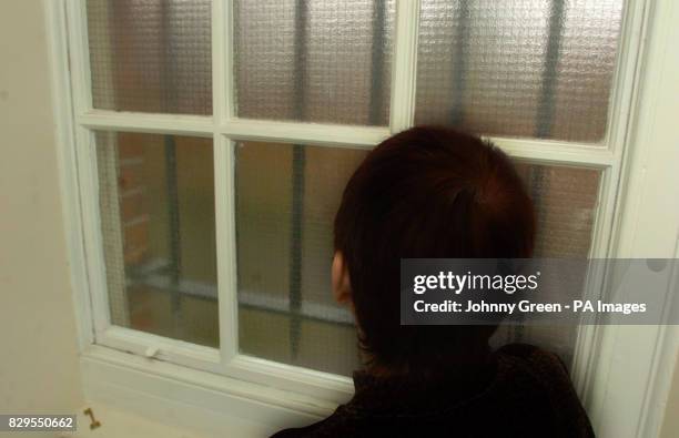 Brenda, looks out of a window after giving interviews to the media telling of her four years of violence and terrifying degradation at the hands of...