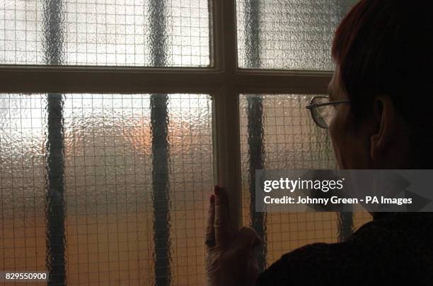 Brenda, looks out of a window after giving interviews to the media telling of her four years of violence and terrifying degradation at the hands of...