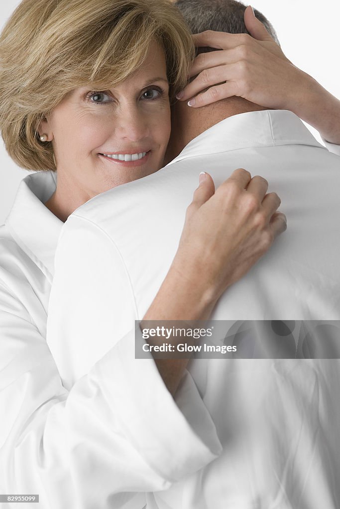 Mature woman and a senior man embracing each other