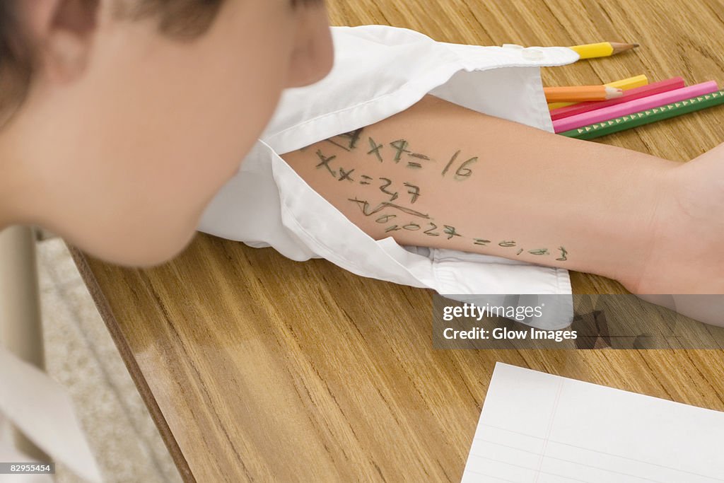 Close-up of a schoolboy copying in an examination