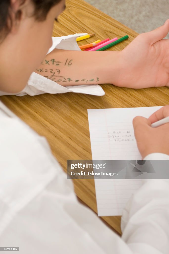 Close-up of a schoolboy copying in an examination