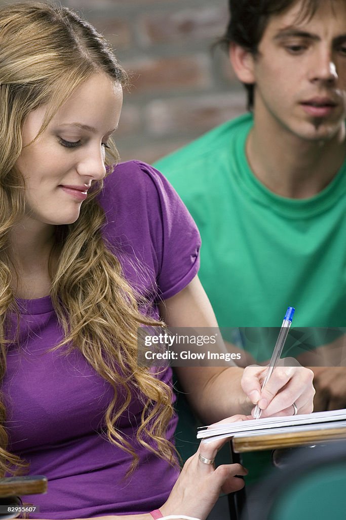 Two university students studying in a classroom