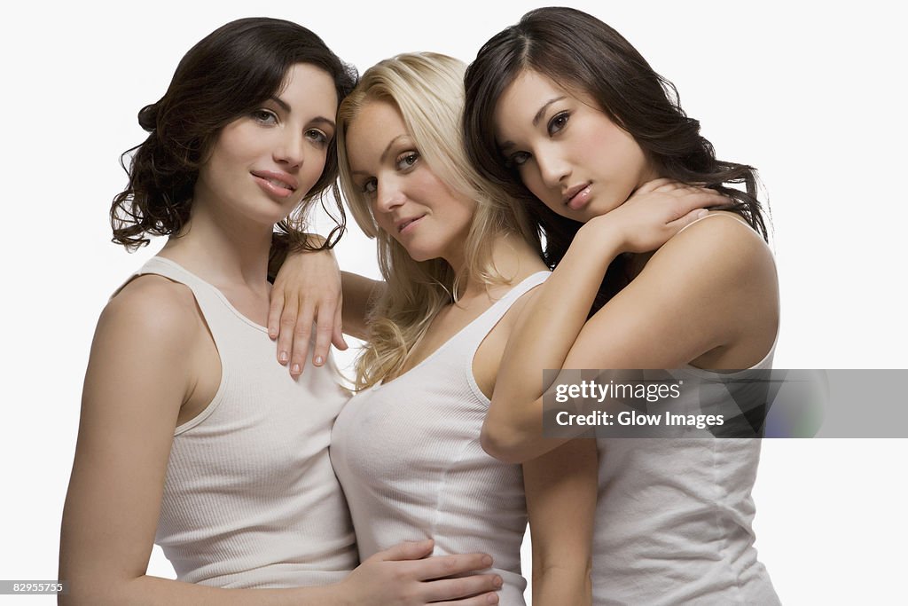 Portrait of three young women standing together