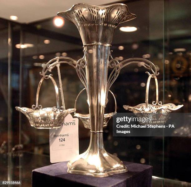 Silver table vase holding three hexagon bonbon dishes from the a la carte Restaurant on the White Star liner Titanic.