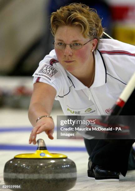 Switzerland's Michele Knobel lets go of the curling stone during the game against Japan.