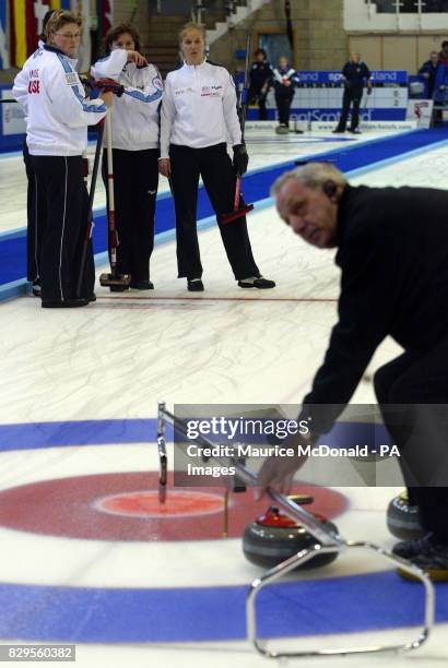 Switzerland's Mjam Ott waits with team members, Michele Knobel , and Brigette Schori looking at the umpire as he gives them 4 points during the game...