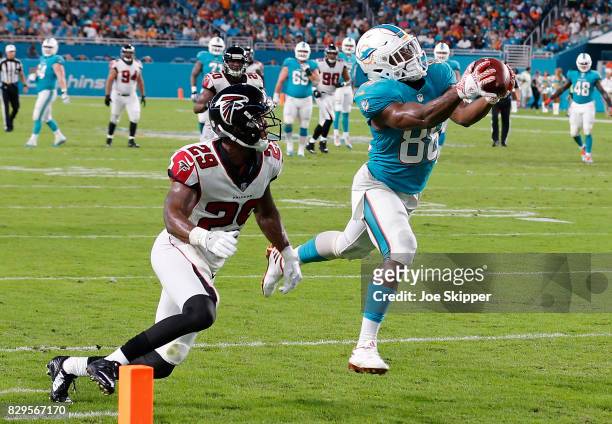 Leonte Carroo of the Miami Dolphins catches Atlanta Falcons pass for Atlanta Falcons second quarter touchdown pass as C.J. Goodwin of the Atlanta...
