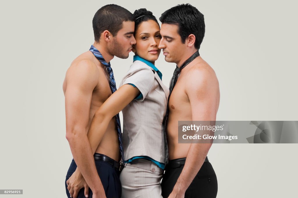 Portrait of a businesswoman standing between two businessmen