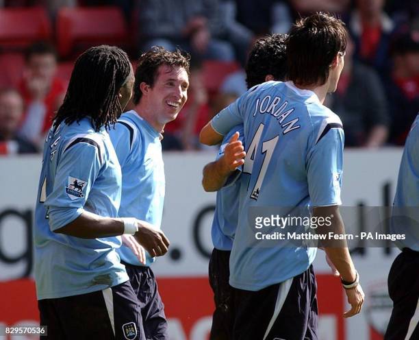 Manchester City's Robbie Fowler celebrates with team mates Kiki Musampa and Stephen Jordan after scoring.