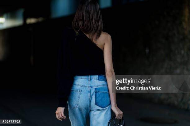 Guest wearing a two tone denim jeans outside Saks Potts on August 10, 2017 in Copenhagen, Denmark.