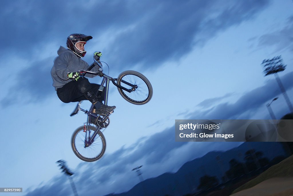 Low angle view of a BMX cyclist performing in mid-air