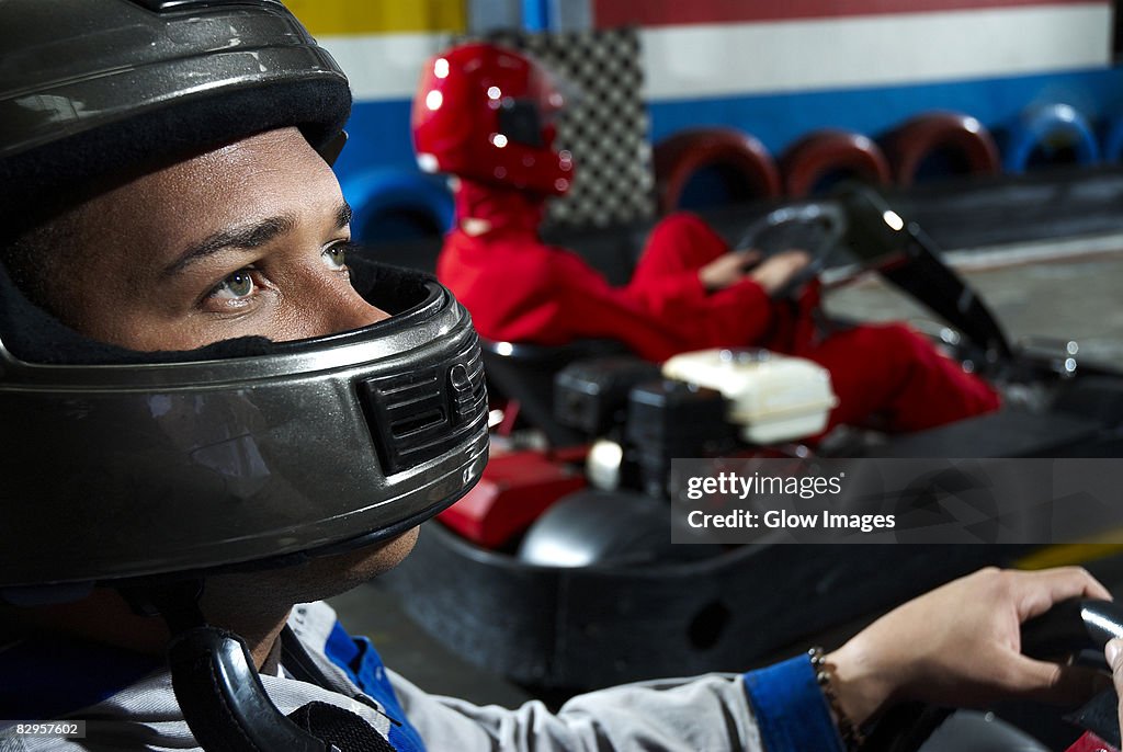 Close-up of a male go-cart racer in a sports car