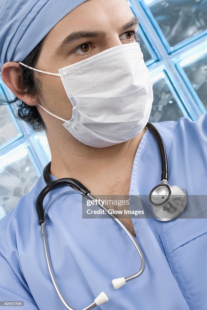 Close-up of a male surgeon wearing a surgical mask