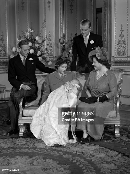 King George VI, left, The Duke of Edinburgh, back, and Queen Elizabeth, right look on as Princess Elizabeth, centre, holds Prince Charles after his...