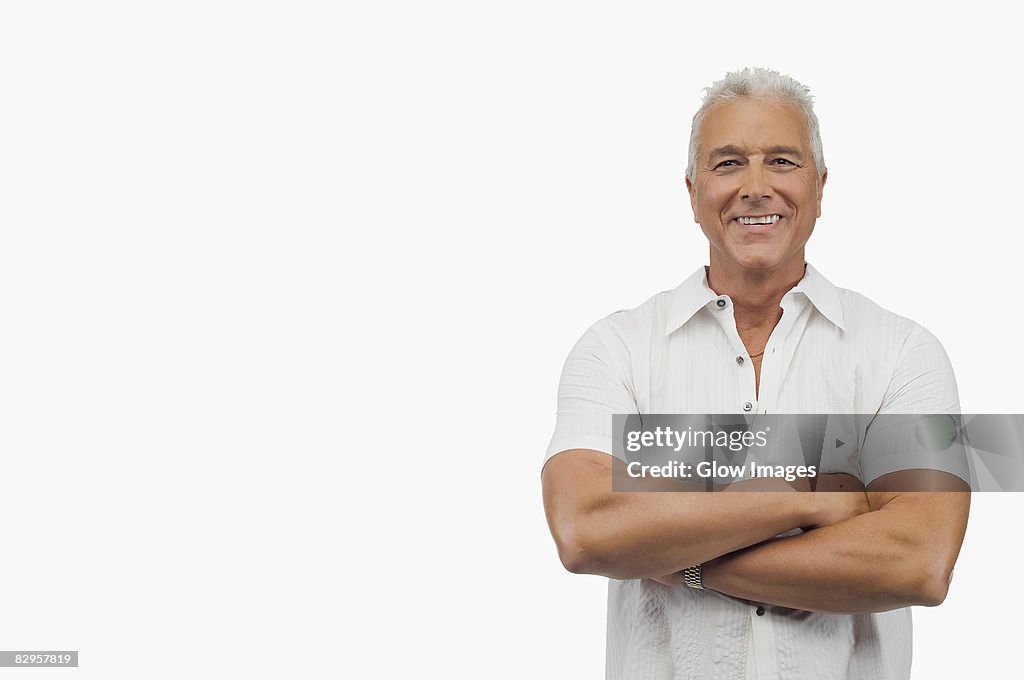 Portrait of a senior man standing with his arms crossed and smiling