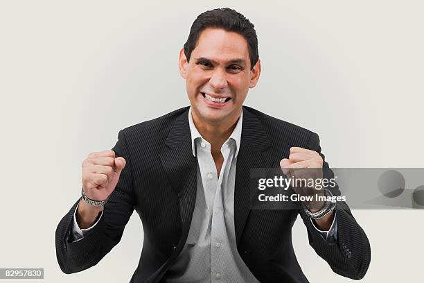 portrait of a businessman cheering - offener kragen stock-fotos und bilder