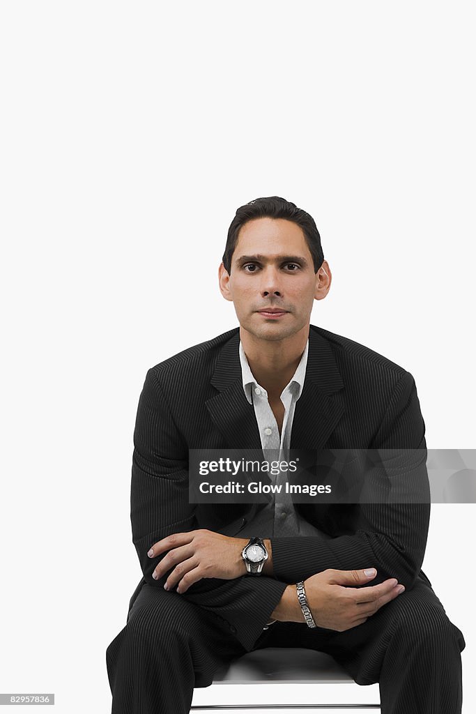 Portrait of a businessman sitting with his arms crossed