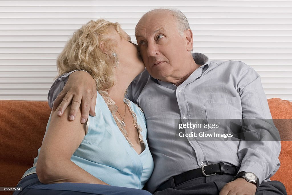 Senior woman kissing a senior man