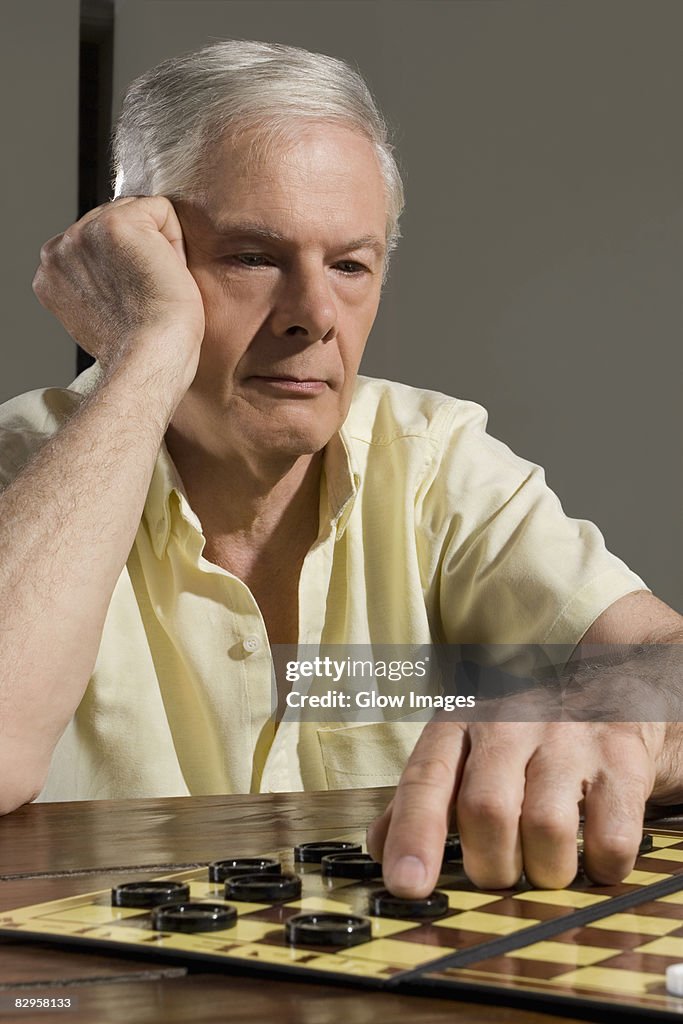 Senior man playing checkers