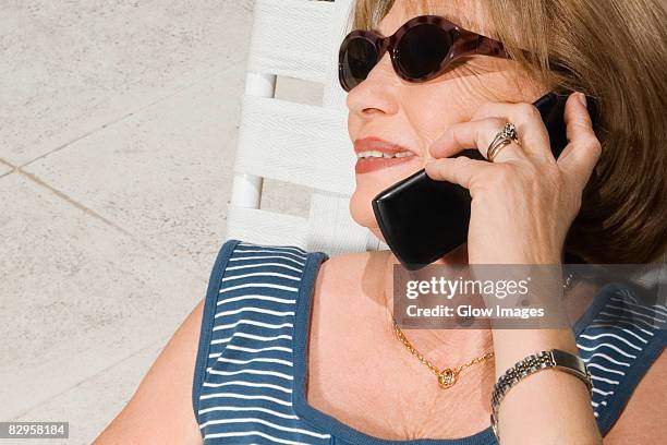 close-up of a senior woman talking on a mobile phone - telefone-de-dobrar imagens e fotografias de stock